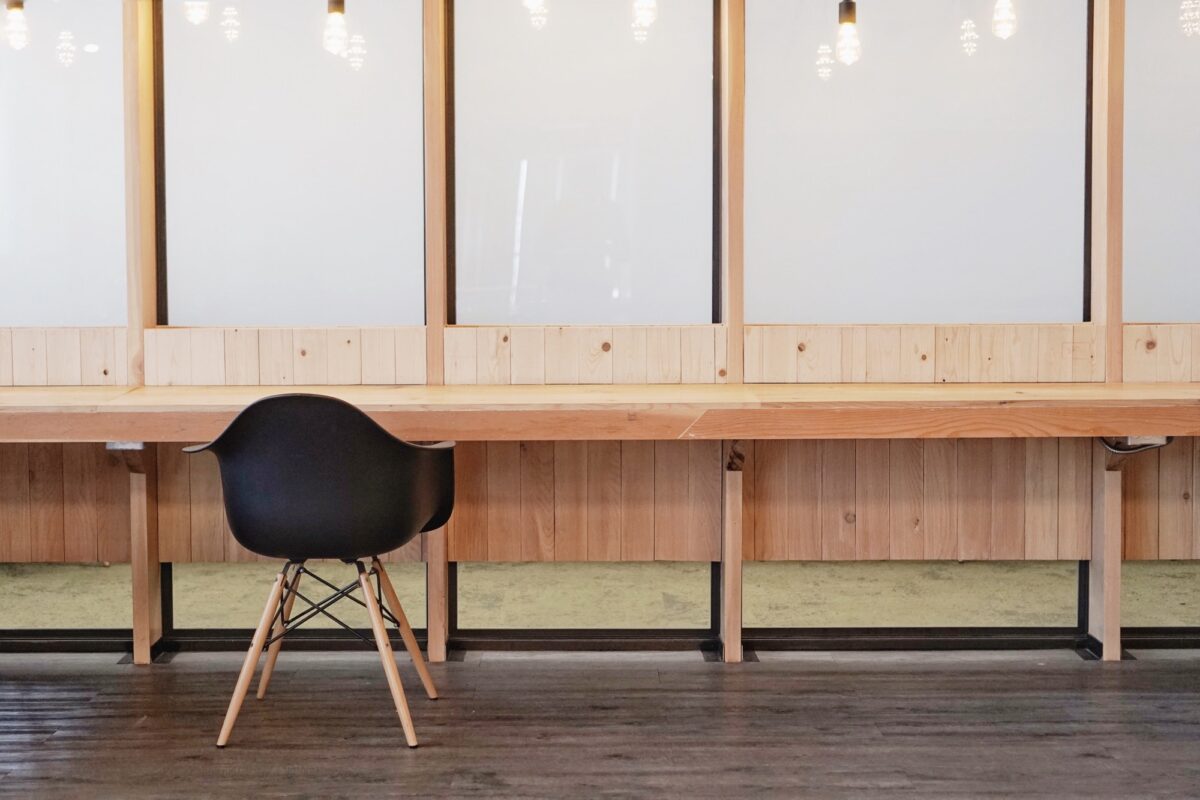 office space with wooden table and black chair for remote work setting