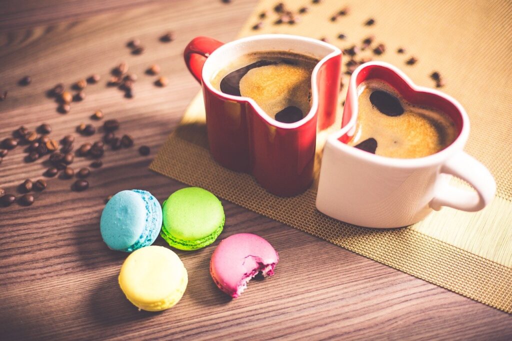 Health Benefits of Coffee: Reasons to Enjoy Your Favorite Caffeine Drink 2 two cups of black coffee with macaroons