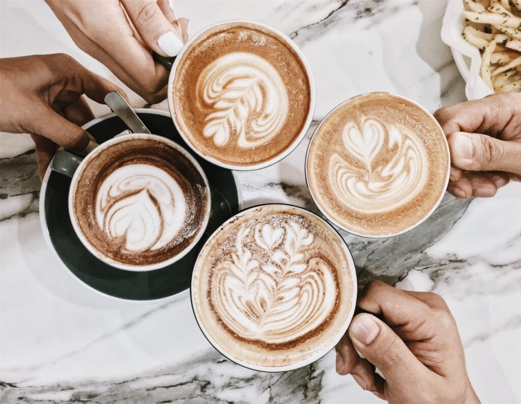 four friends enjoying cups of coffee